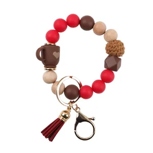 Beaded bracelet keychain with silicone and wooden beads, coffee cup charm, and red tassel