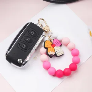 Colorful silicone beaded keychain bracelet with a pencil-shaped bow charm and clip