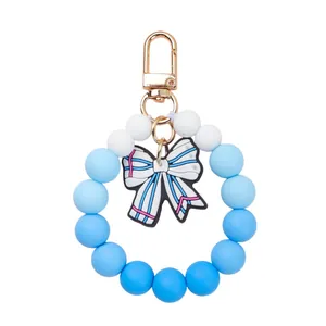 Blue gradient silicone beaded keychain bracelet with striped bow charm