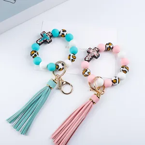 Close-up detail of silicone beaded keychains with colorful tassels and leopard print beads