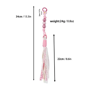 Handmade pink beaded tassel bag charm with detailed dimensions and weight specifications