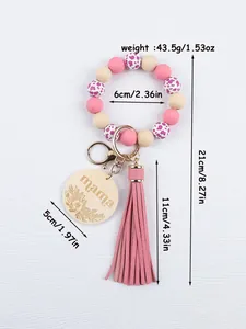 Detailed view of handmade silicone bead keychain with mama wood charm and leather tassel