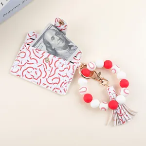 Close-up of baseball-themed silicone bead keychain with leather card holder and tassel