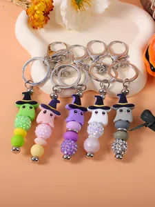 Detail view of five colorful Halloween beaded ghost keychains with wizard hats.
