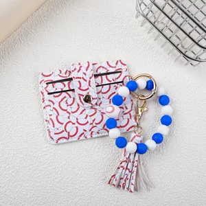 Detail of baseball pattern leather cardholder with blue and white silicone bead keychain