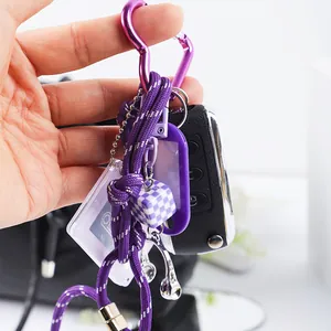 Close-up detail of a purple DIY keychain featuring a heart buckle and headphone charms