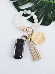 Close-up of silicone beaded wristlet keychain with wood 'mama' charm and tassel