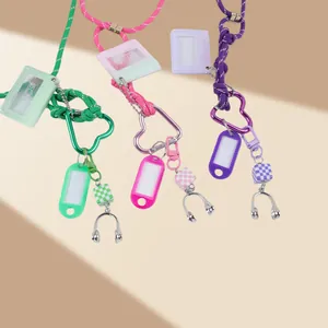 Detail view of heart-shaped carabiner keychains with mini cassette photo frames.