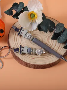 Detailed close-up of cute Halloween ghost beaded pen and matching keychain accessory.