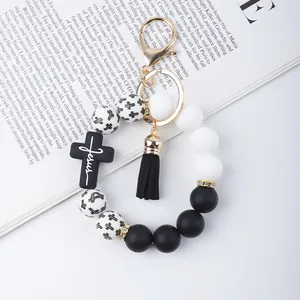 Detailed view of a stylish beaded keychain bracelet featuring a Jesus cross and black PU tassel