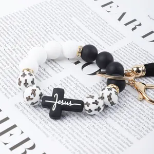 Detailed macro shot of beaded cross bracelet with Jesus pendant and PU tassel.