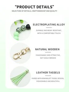 Detail view of mint green beaded keychain with leather tassel and gold alloy clasp.