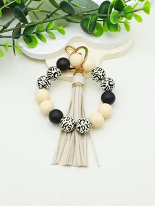 Detail view of handmade silicone bead wristlet keychain with leopard print and PU tassel