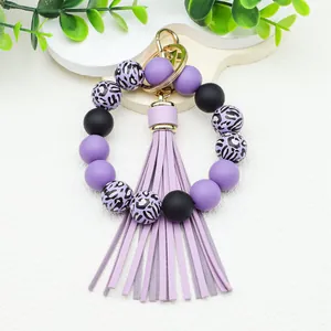 Beaded wristlet keychain featuring purple leopard print silicone beads and PU tassel