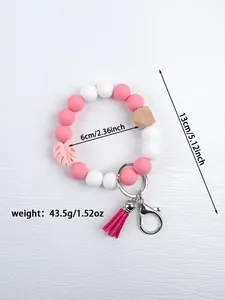 Detailed view of pink and white silicone beaded keychain with tassel and dimensions