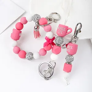 Detailed view of pink silicone beaded nurse life keychain with cup charm