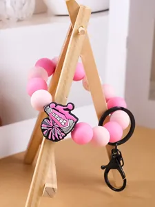 Vista detallada de pulsera de cuentas de silicona rosa con amuleto de megáfono de animación