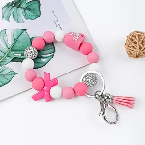 Close-up detail of pink silicone beaded wristlet with Nurse Life charm and tassel.