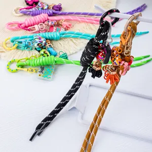 Detailed view of colorful braided rope keychains with vibrant charms and tassels
