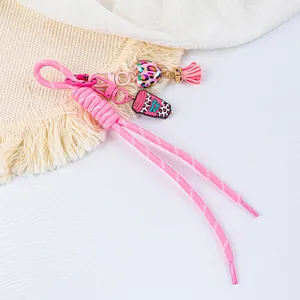 Detailed view of handmade pink braided rope keychain with leopard heart and tassel