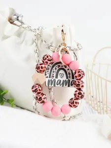 Pink leopard silicone bead mama keychain on white designer bag