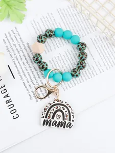 Detailed view of leopard print rainbow wood bead wristlet keychain with Mama charm