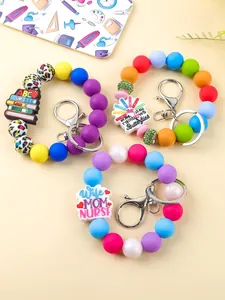 Detailed view of silicone bead wristlets with teacher and nurse themed charms