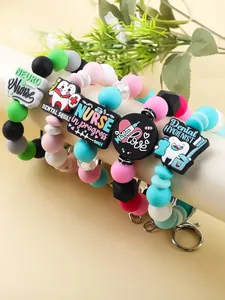 Detail view of cute silicone beaded keychains with nurse and dental hygienist charms.