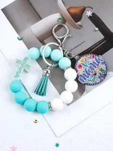 Silicone beaded keychain bracelet featuring cross, mama charm, and stylish tassel detail