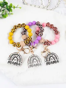 Detailed view of leopard print silicone bead keychains featuring mama acrylic charms.