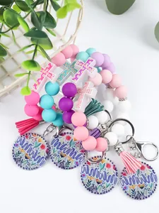 Detail of pastel silicone bead keychain bracelets with floral Mama charms and tassels