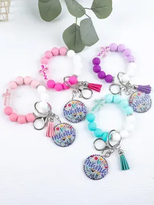 Assorted colorful silicone bead keychains featuring floral mama charms and decorative tassels
