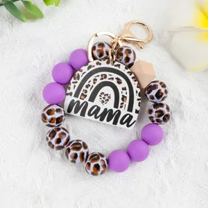 Leopard print rainbow mama beaded keychain wristlet with purple silicone beads.