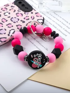 Close-up view of a colorful silicone beaded keychain featuring a Love and syringe charm