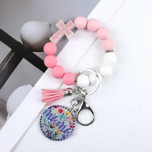 Silicone bead keychain bracelet with pink tassel and floral mama tag and cross charm