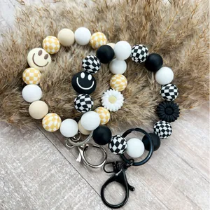Silikon Perlenarmband Schlüsselanhänger mit Karomuster, Smiley und Blumenanhänger