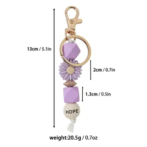 Vue détaillée du porte-clés en silicone marguerite violette avec poids et dimensions