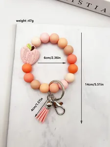 Detailed size diagram for silicone beaded apple keychain with pink tassel and weight