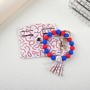 Detail of baseball-themed silicone bead bracelet with cardholder and tassel