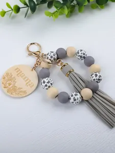 Handmade silicone bead wristlet keychain with cow print beads and mama wooden disc tassel