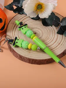 Detail of Halloween green ghost beaded pen and keychain set with witch hat motif