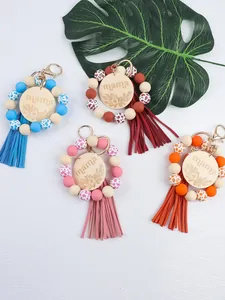 Handcrafted silicone bead keychain set with mama engraved wood charms and tassels.