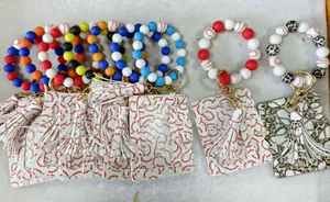 Detail view of silicone bead wristlets with baseball card holders and leather tassels.