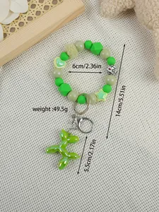 Close-up view of green beaded keychain with balloon dog charm and size measurements