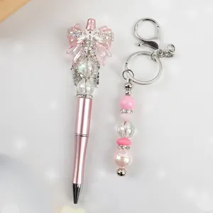 Elegant pink beaded pen and keychain set with bow and crystal rhinestones