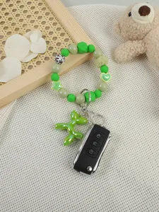 Close-up of green beaded wristlet keychain with cute lime green balloon dog charm