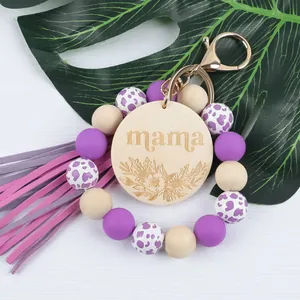 Handmade purple silicone bead wristlet keychain with engraved mama wood disc and tassel