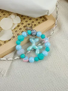 Close-up of a blue iridescent balloon dog charm on a colorful pastel beaded keychain accessory