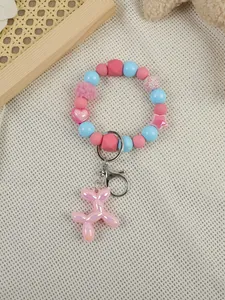 Detailed view of a cute pastel beaded bracelet keychain featuring a pink balloon dog pendant