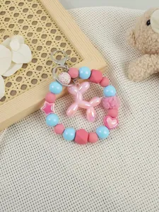 Detailed close-up of a pink balloon dog charm on a pastel beaded bracelet keychain